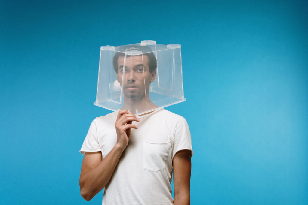 Man wearing plastic box on head